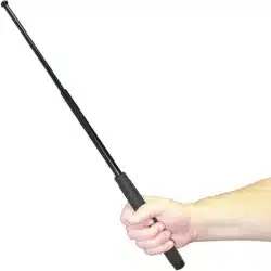 Hand holding expandable steel police baton